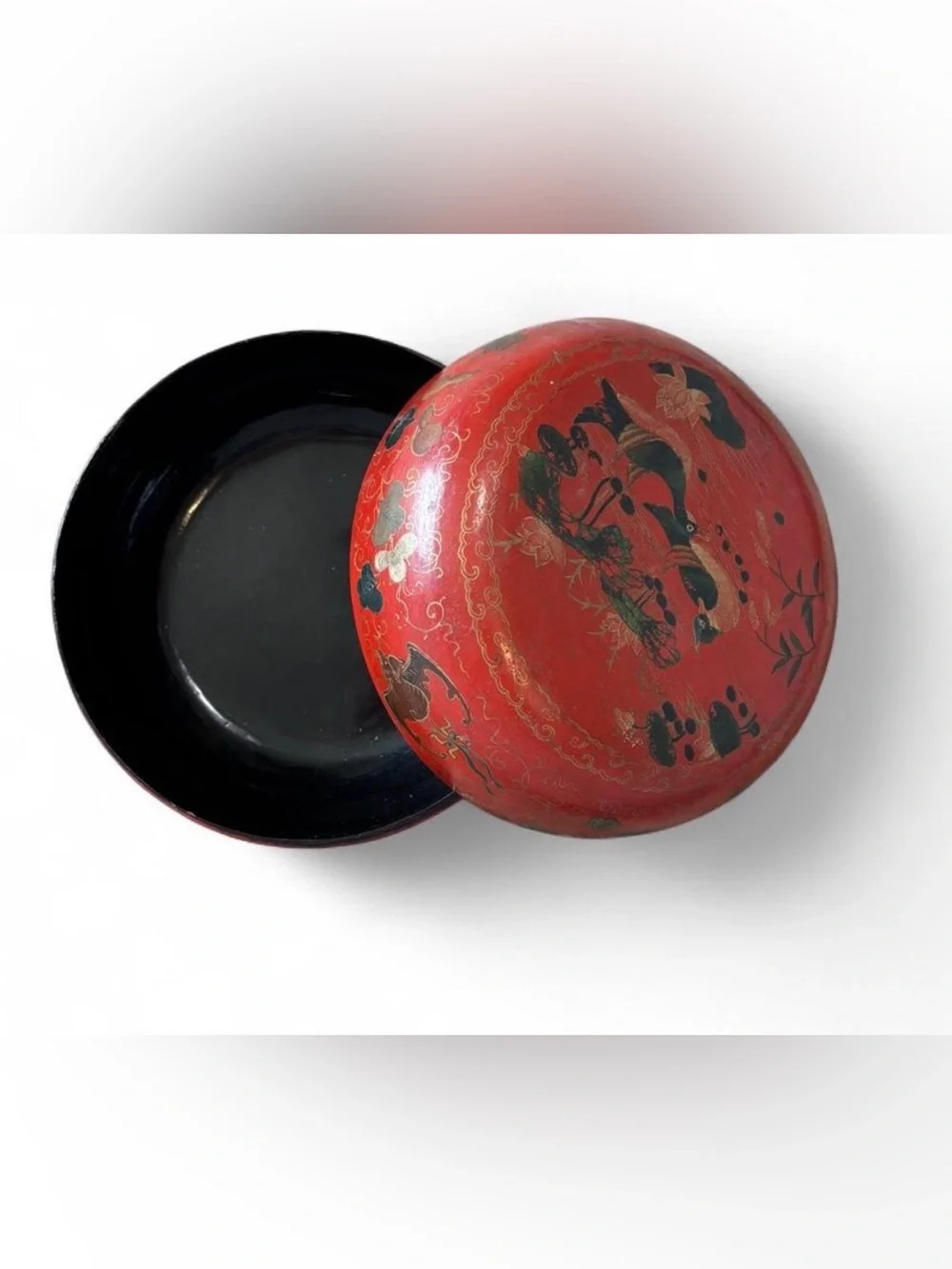 Japanese lacquerware box with black and gold painted figures on red background
